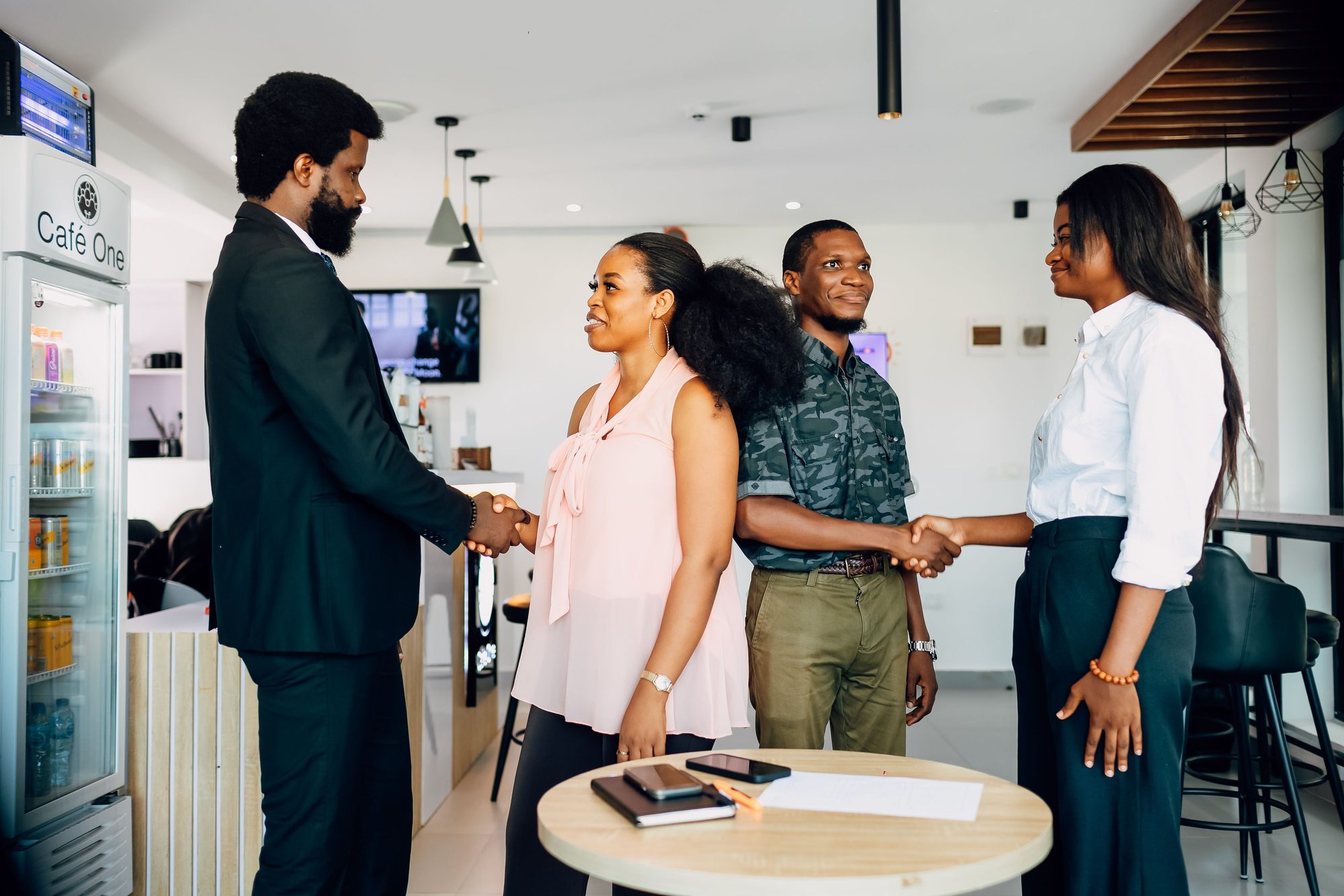 In-person handshake between Maison ECAL staff and a partner