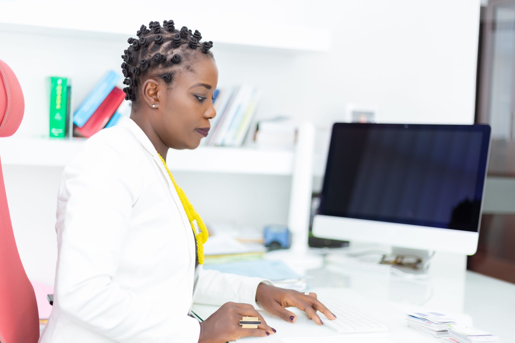 Staff member following up on an online inquiry from a desk computer