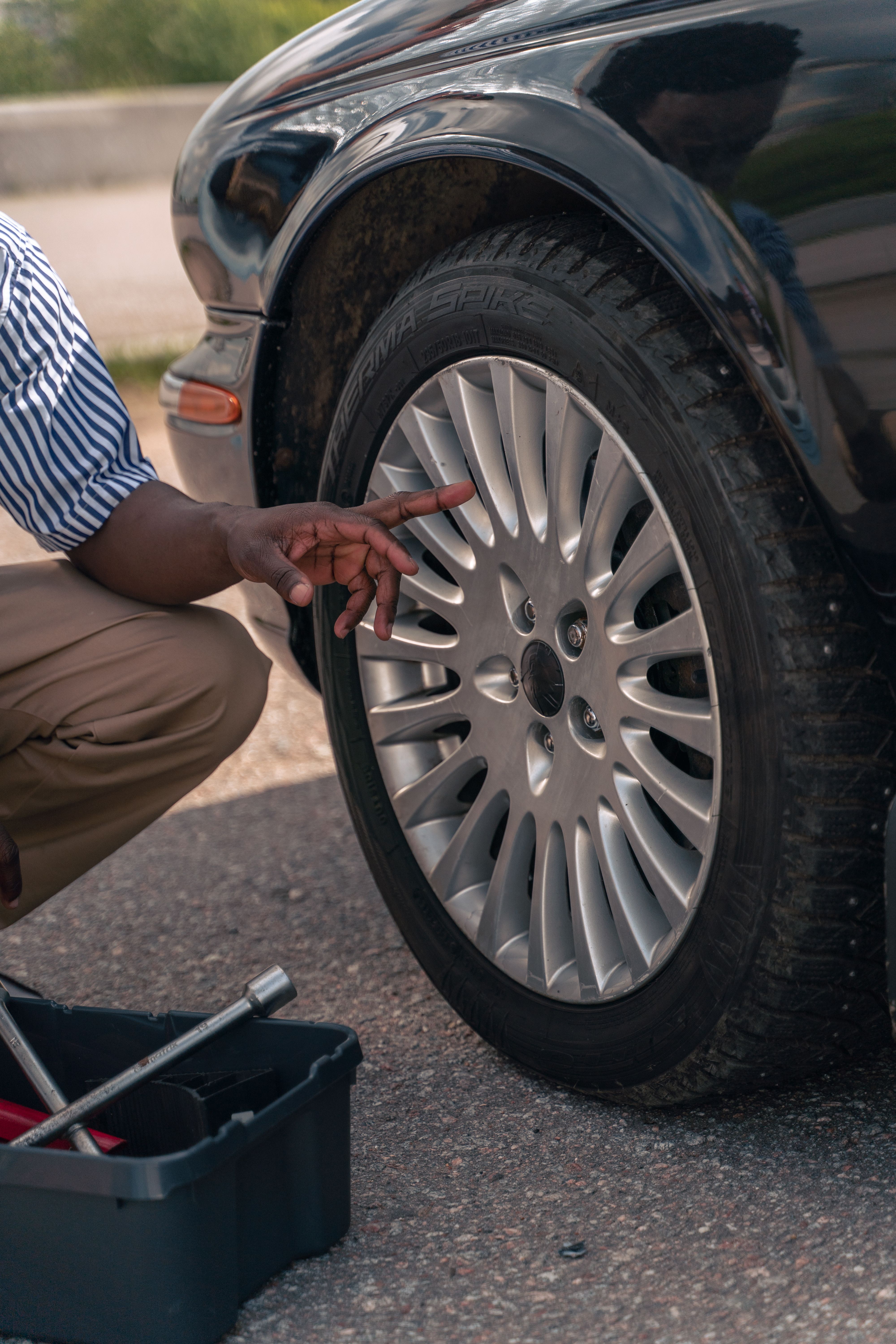 Technician inspecting a vehicle tire as part of a preventive fleet maintenance check
