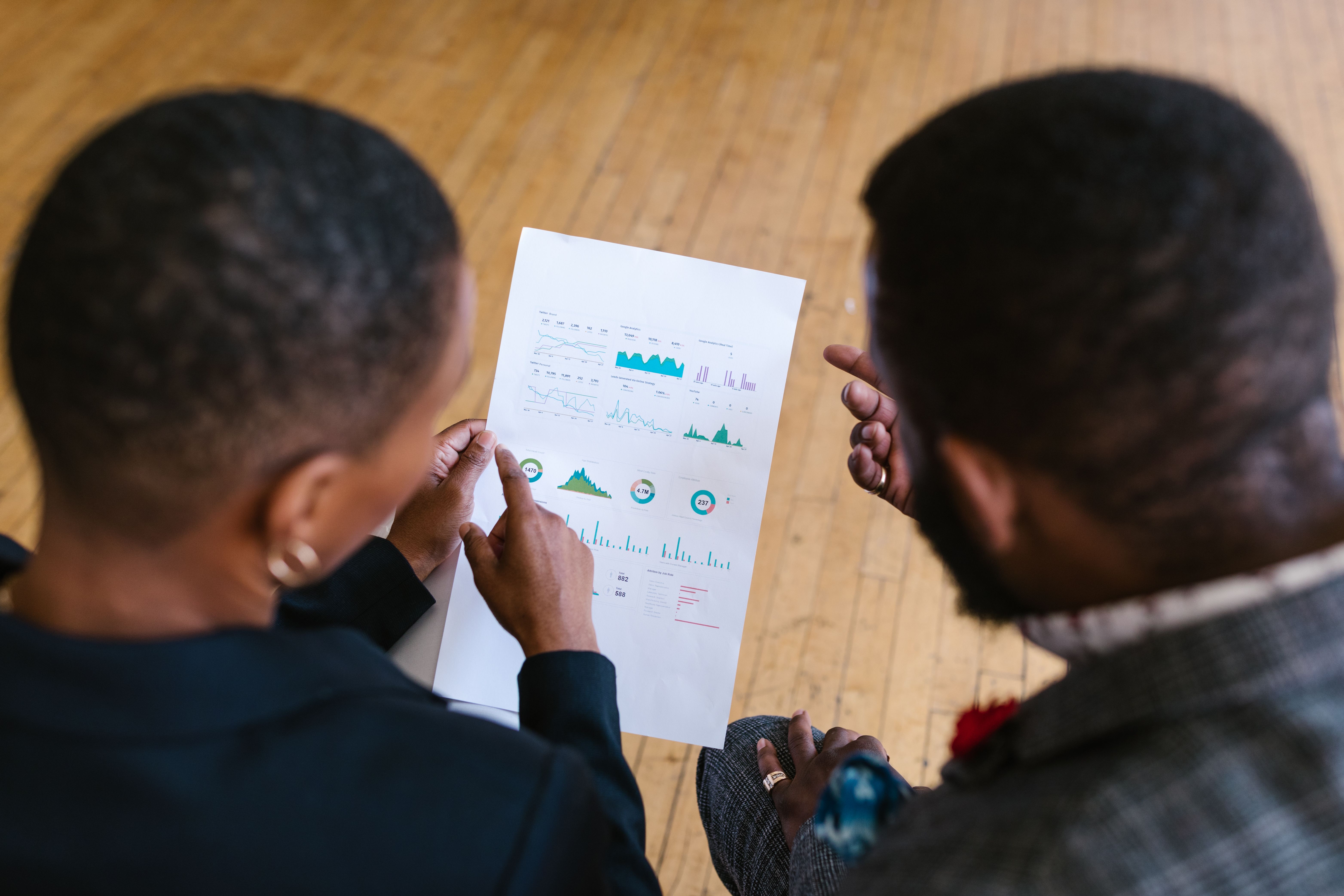 Consultants reviewing market research and strategy charts together