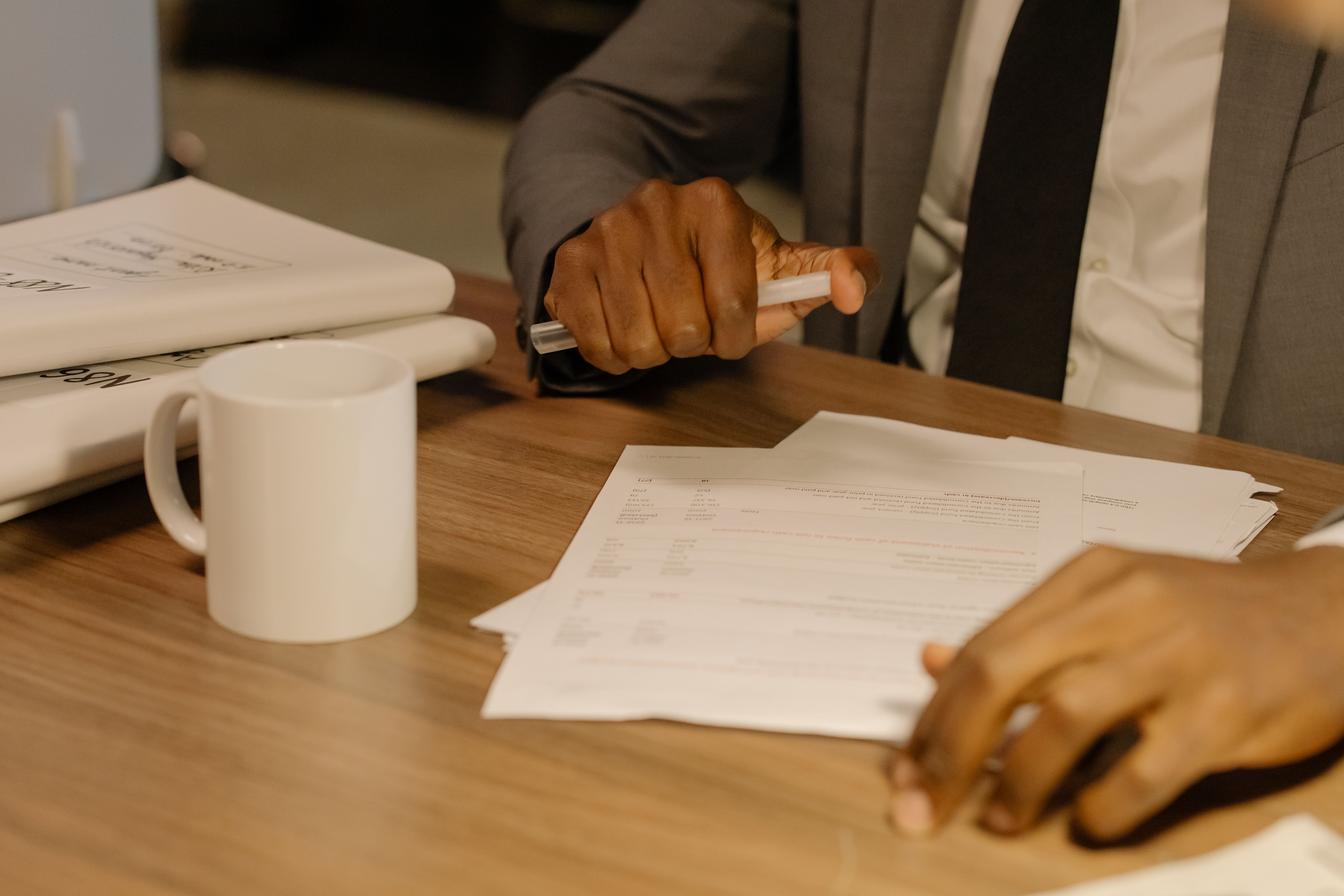 Procurement documents and compliance paperwork on a table