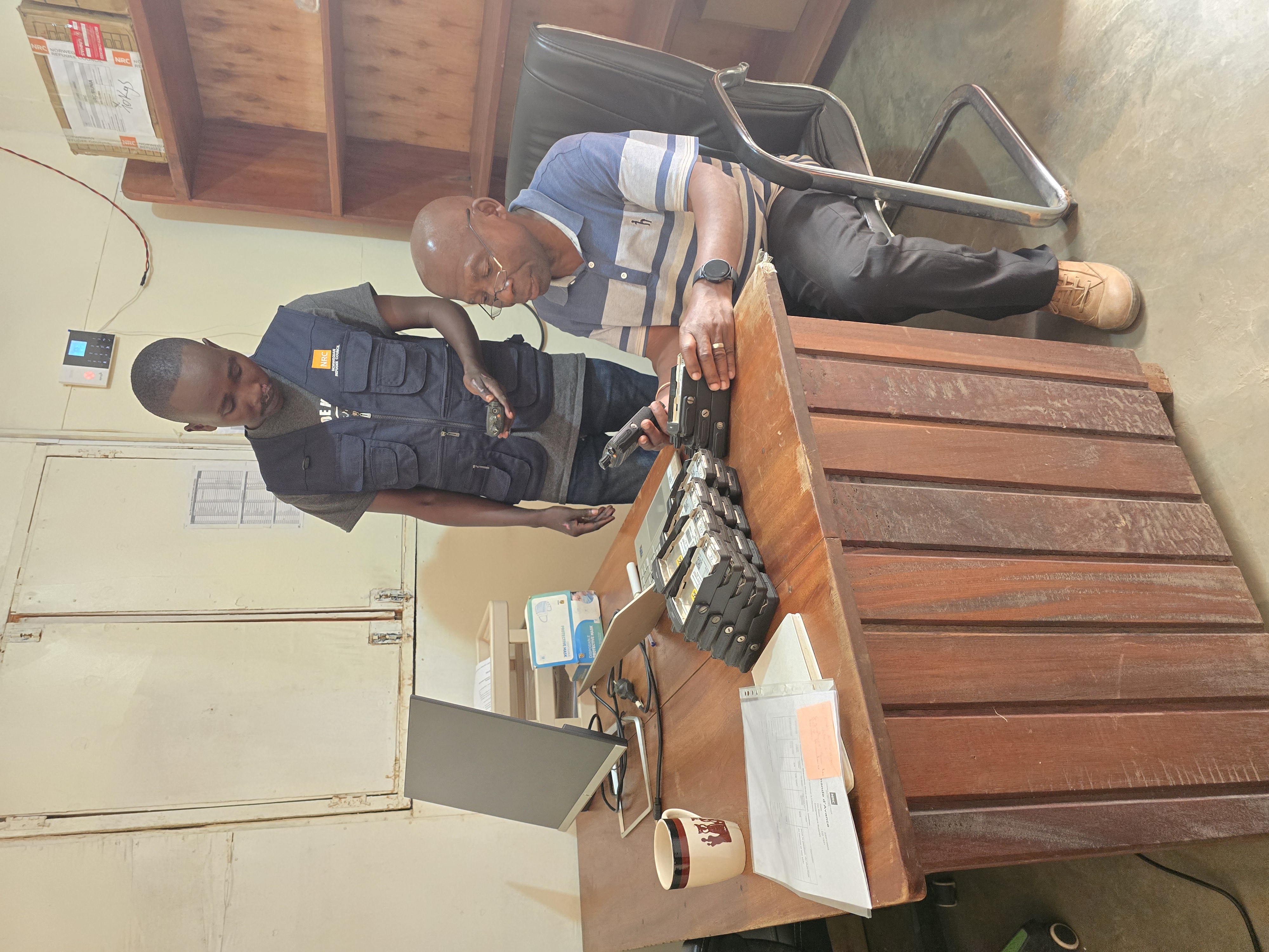 Staff member checking and logging an order against a clipboard